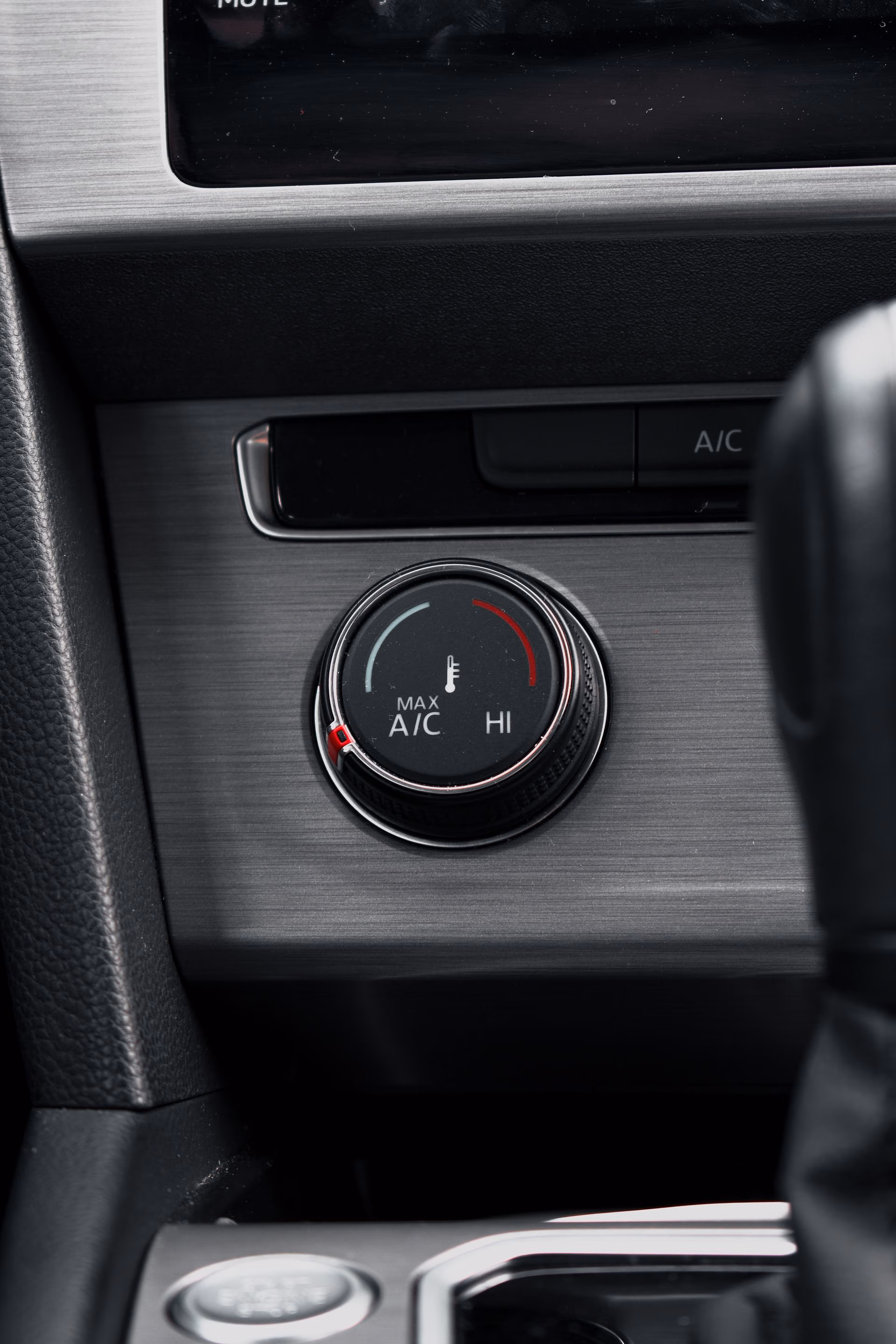 Car climate control knob showing temperature settings from Max A/C to High heat.