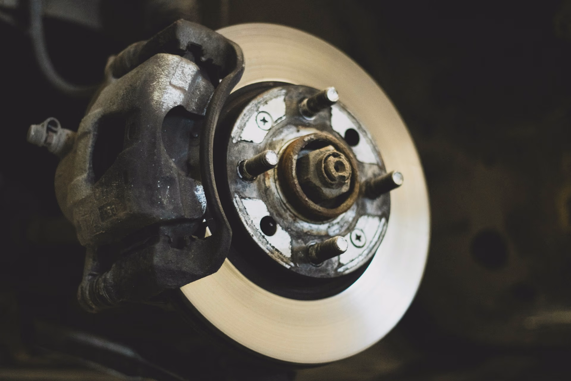 Close-up of a car's brake rotor and caliper assembly without the wheel attached.